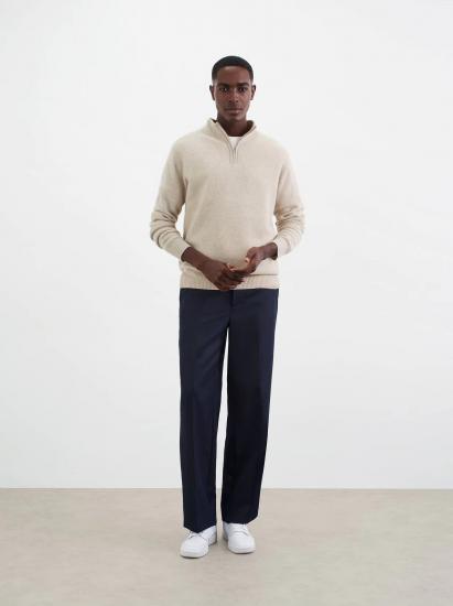 Beige half zip sweater on male model