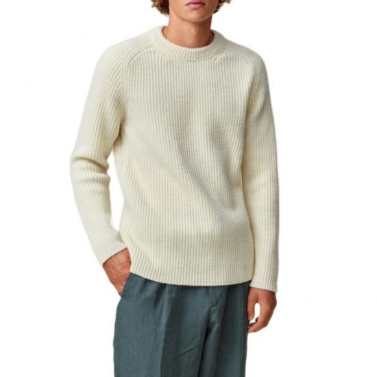 Cream colored ribbed sweater on model