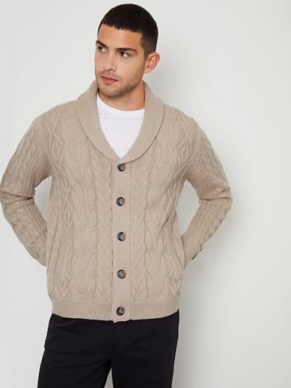 Beige cable knit cardigan on model